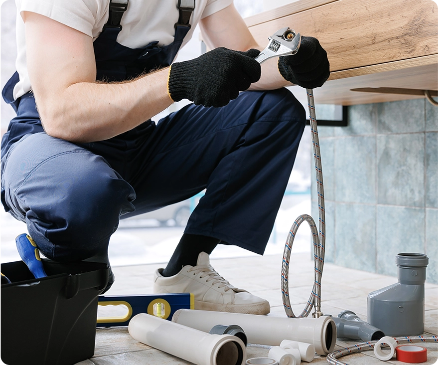 Plumber man fix repair service wraps fluoroplastic sealing material tape around faucet hose. Concept install plumbing in bathroom.