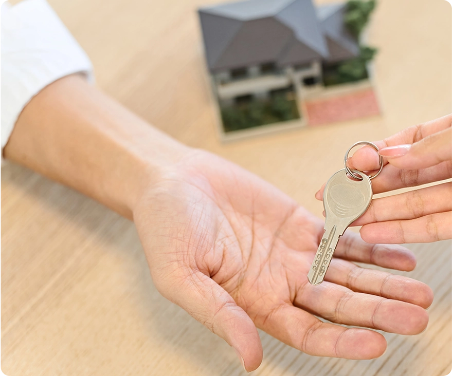 Hand of a woman handing over the house key